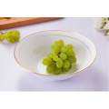 White porcelain fruit bowls with gold rim.